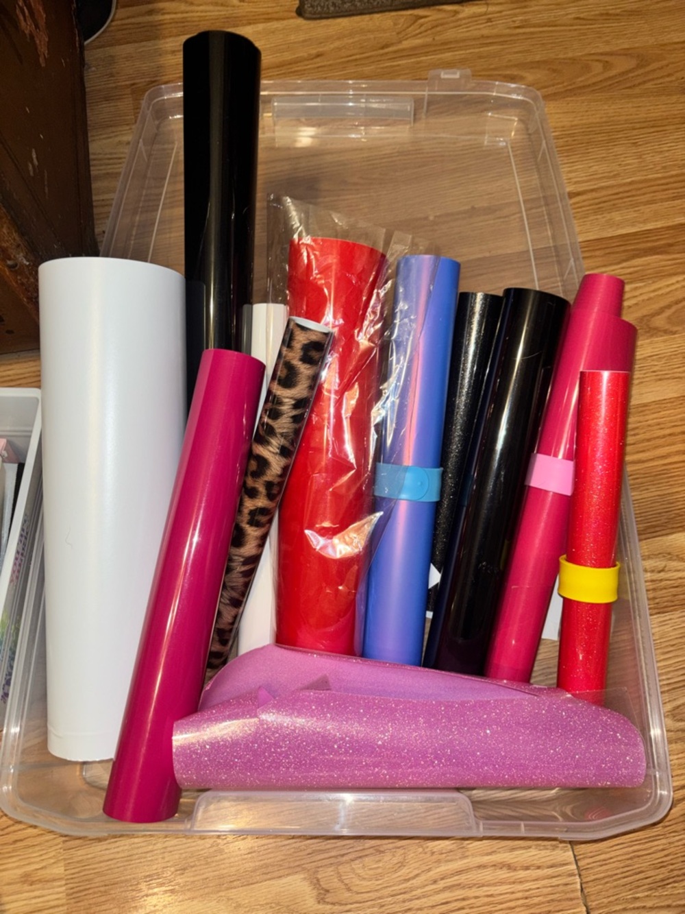 Clear organizer bin full of iron on vinyl. Shimmer, glitter; holographic vinyl
